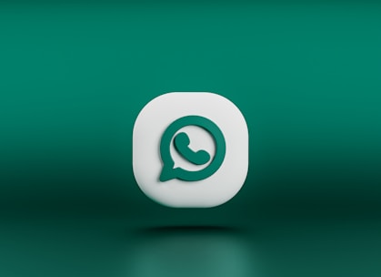 A three-dimensional icon resembling the logo of a chat application, featuring a white speech bubble with a green telephone handle inside. The icon is set against a gradient green background and appears to be floating.