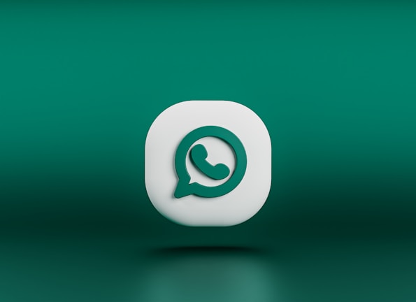 A three-dimensional icon resembling the logo of a chat application, featuring a white speech bubble with a green telephone handle inside. The icon is set against a gradient green background and appears to be floating.
