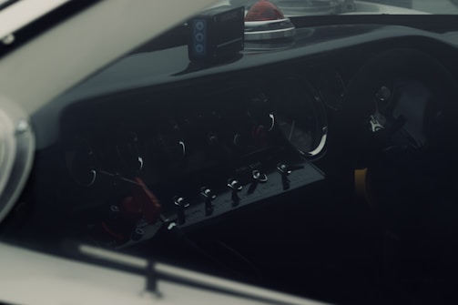 A sleek camper van dashboard featuring the PowerAlert device lit up