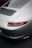 Side profile of a luxury car featuring a smooth satin paint protection film reflecting ambient light.