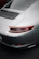 Side profile of a luxury car featuring a smooth satin paint protection film reflecting ambient light.