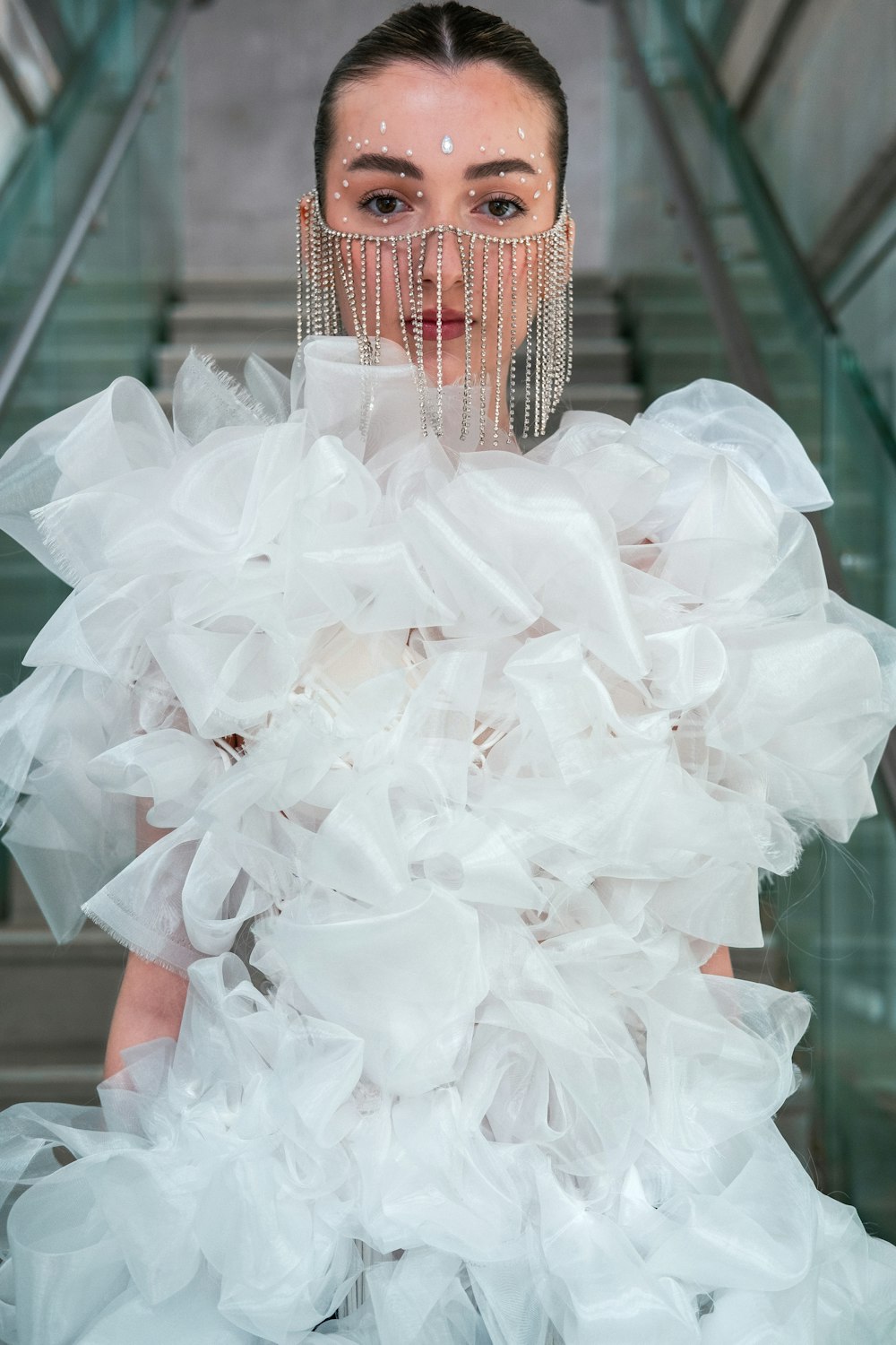 a woman in a white dress with a large amount of ruffles on her