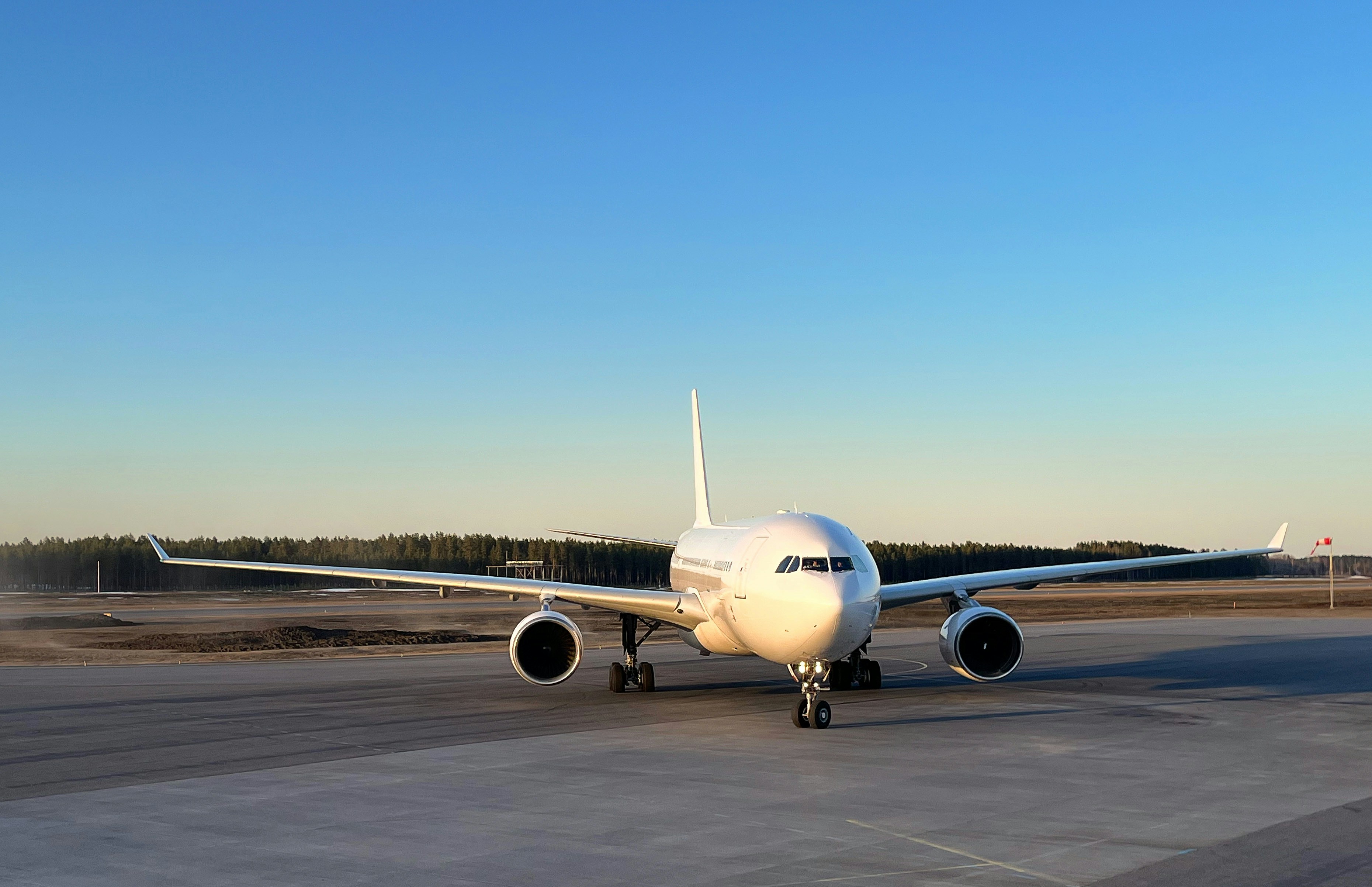 a large jetliner sitting on top of an airport tarmac, 
