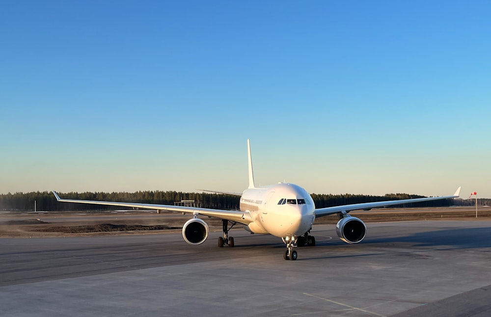 a large jetliner sitting on top of an airport tarmac