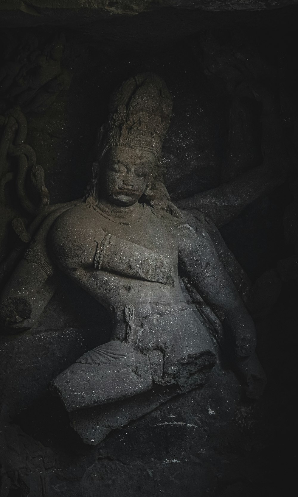 a statue of a person in a cave