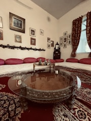Cozy sitting nook with cushions and a rustic wooden coffee table in the deluxe room.