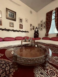 A cozy living room featuring a plush velūra carpet under a wooden coffee table.