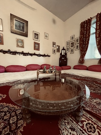 A cozy carpeted living room in a Qatari home, featuring warm tones and plush textures.