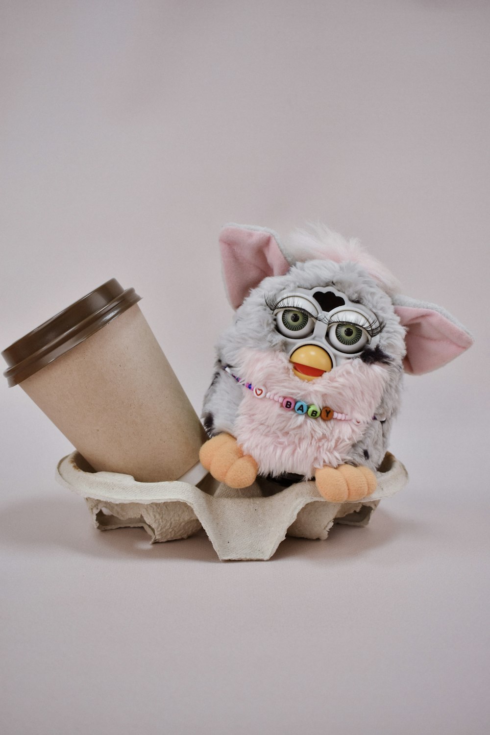 a stuffed animal holding a cup of coffee