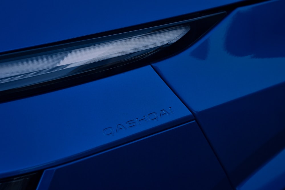 a close up of a blue sports car