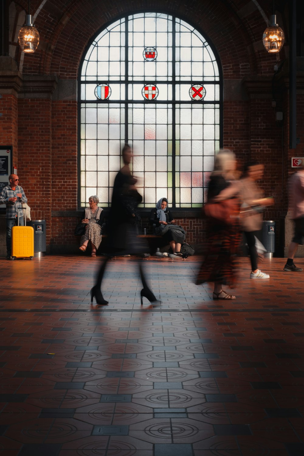 a group of people walking around a train station