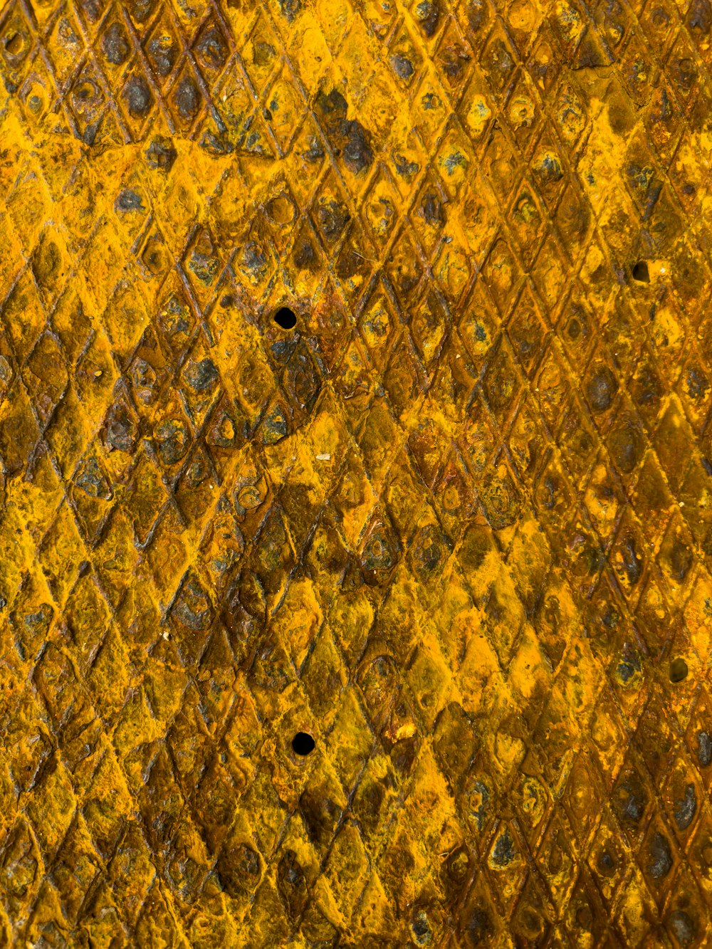 a close up of a yellow and black diamond pattern