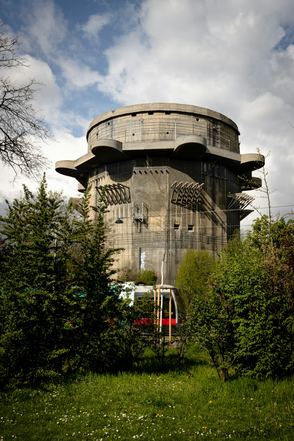 a round building sitting in the middle of a lush green field