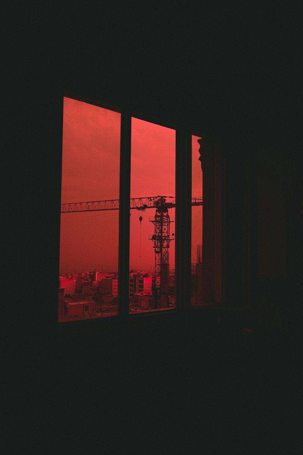 a red sky seen through a window of a building