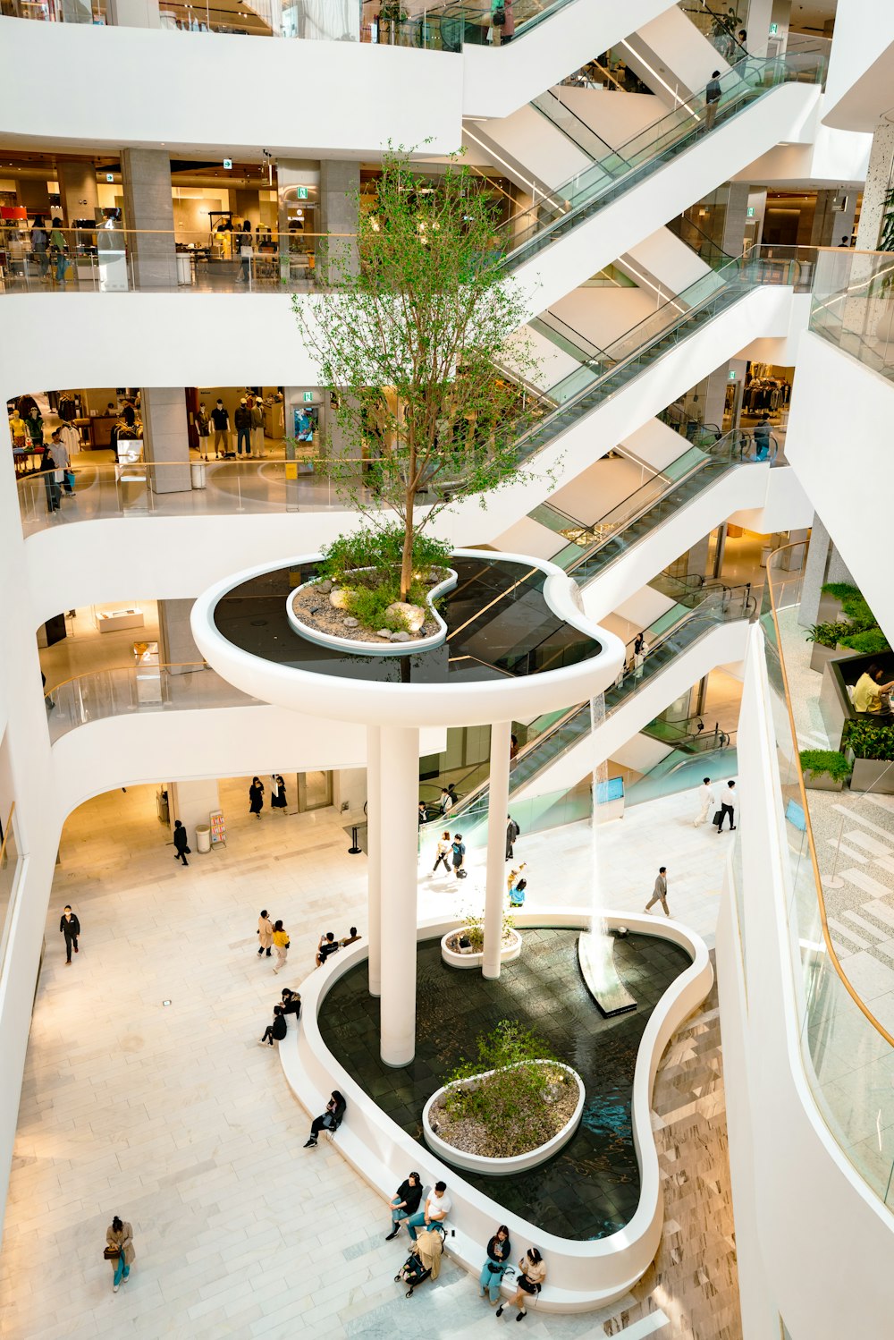 a group of people walking around a mall