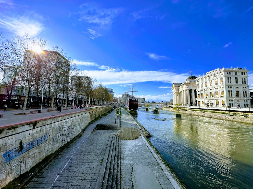 a river running through a city next to tall buildings