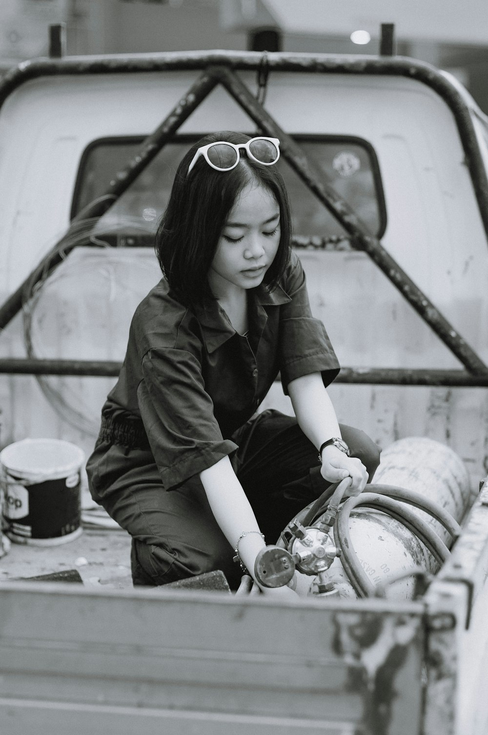 a woman sitting in the back of a pick up truck