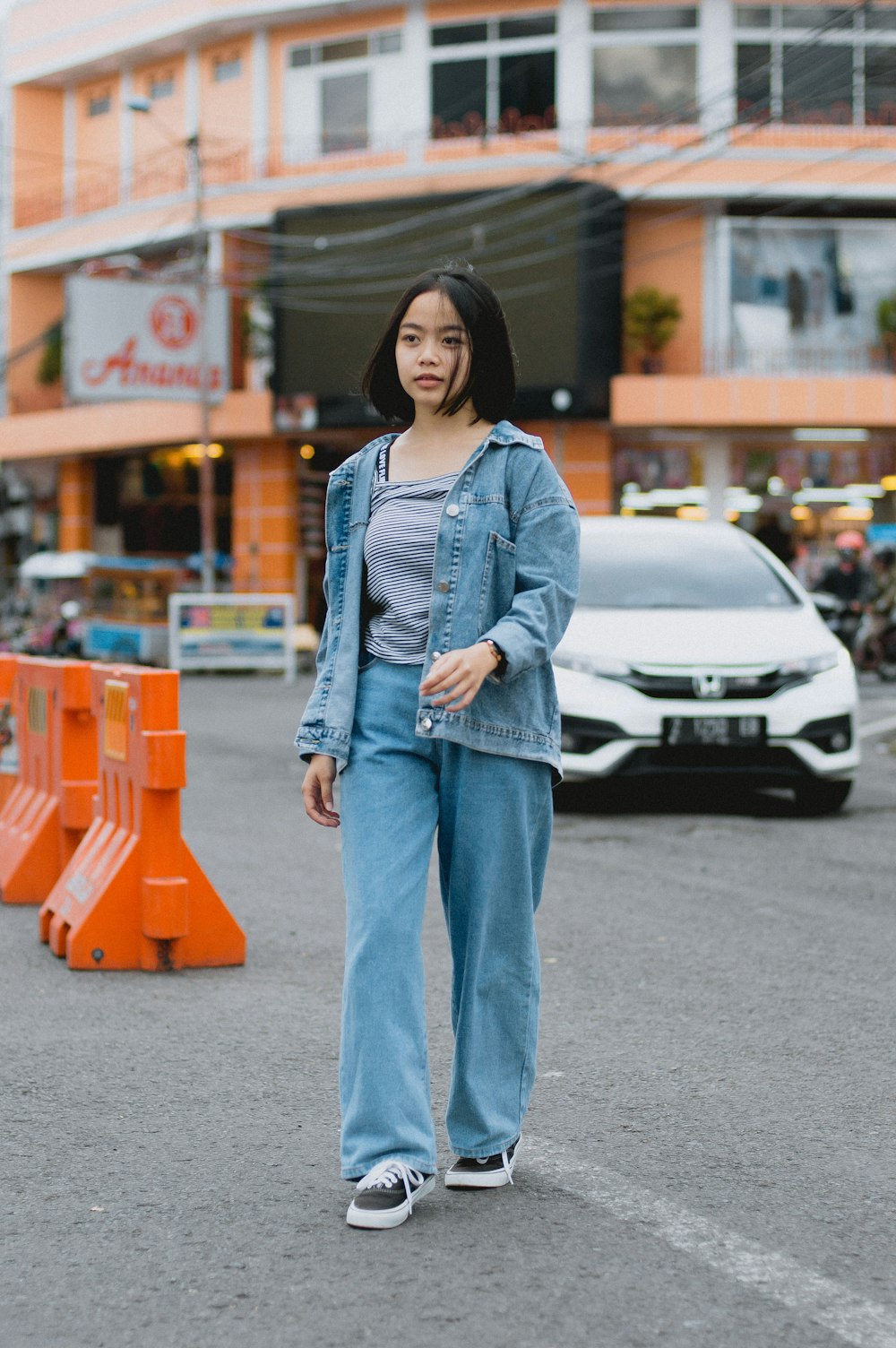 a woman standing in the middle of a street