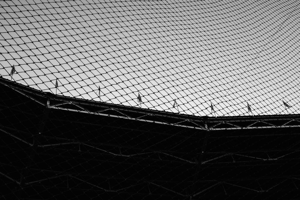 a black and white photo of a tennis court net
