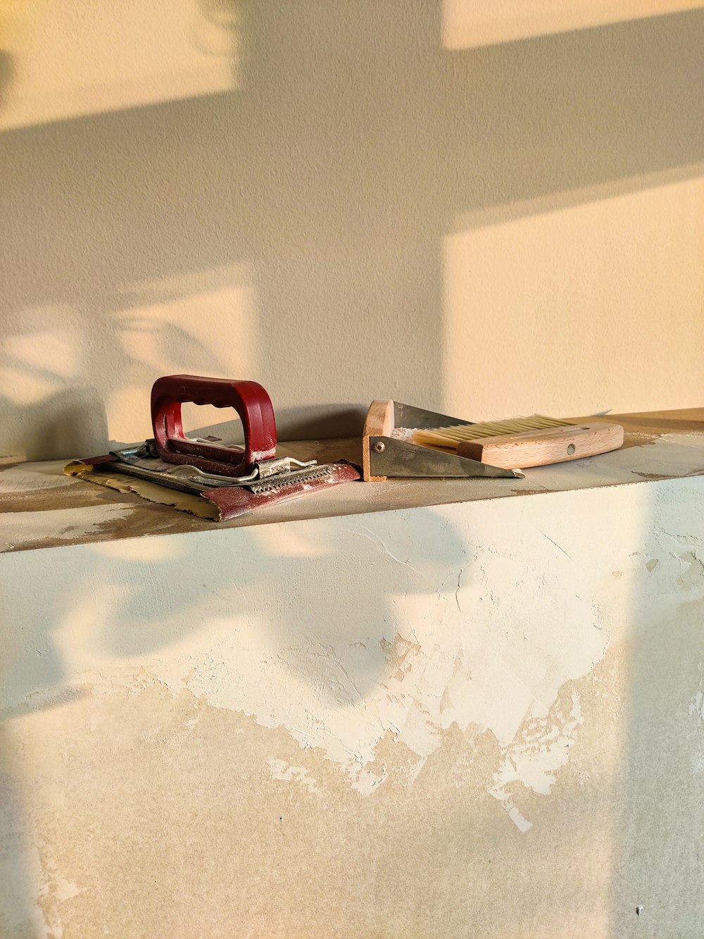 a pair of scissors sitting on top of a piece of wood