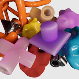 A dynamic display of resin figures in various bright colors and asymmetrical blob shapes.