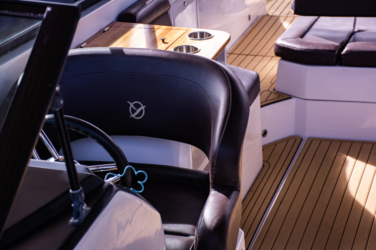 Boat captain's chair with white marine vinyl upholstery on the open water