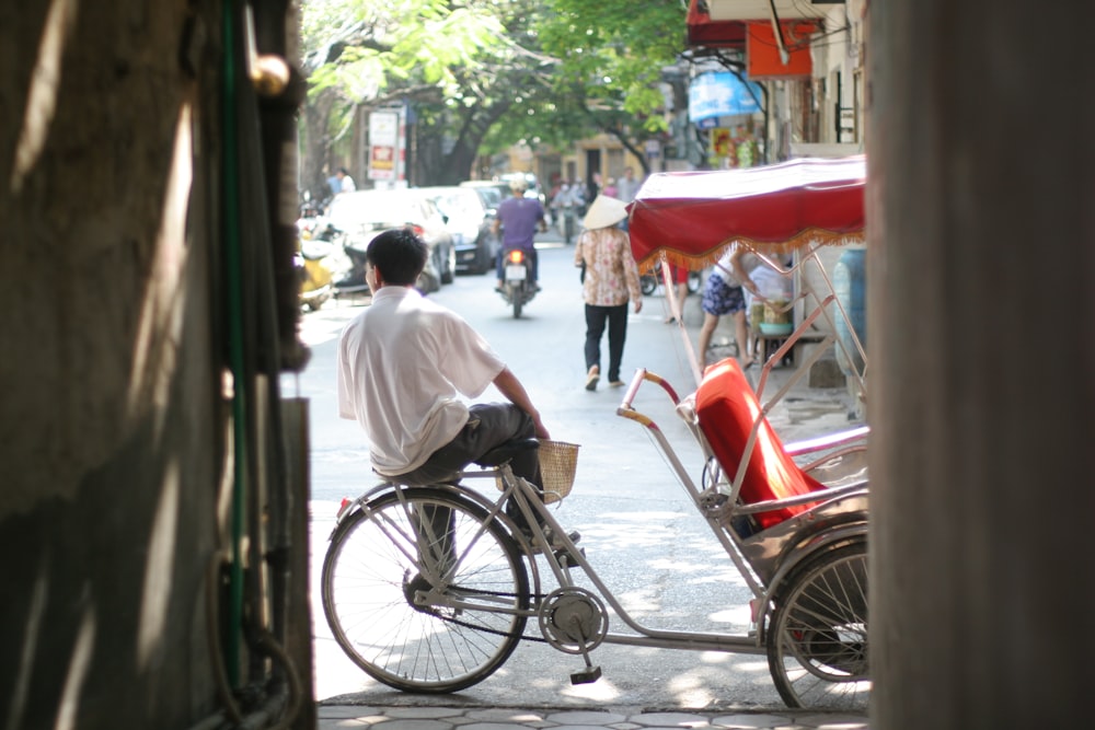 a man riding a bike down a street