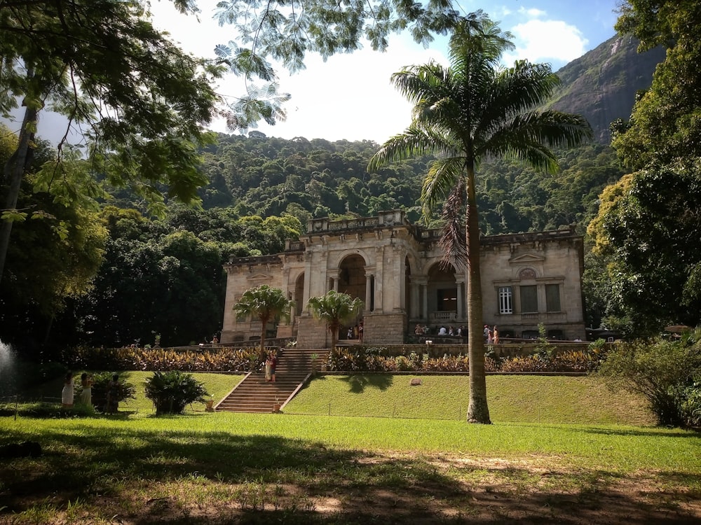 a large building surrounded by lush green trees