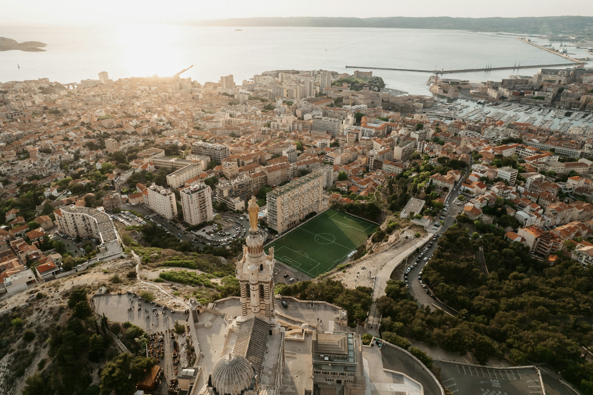 an aerial view of a city with a soccer field
