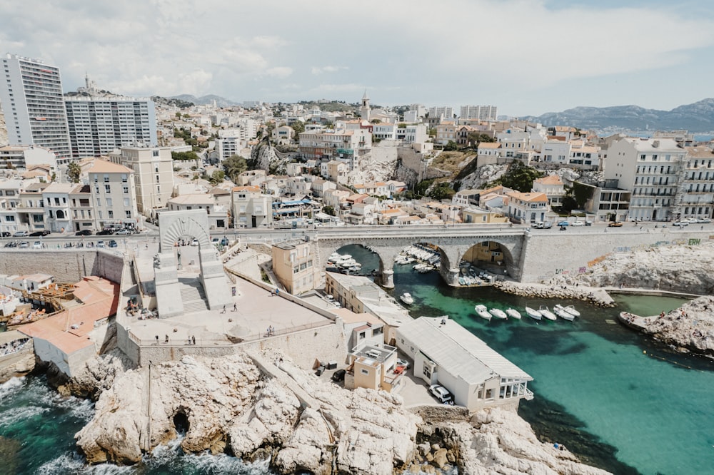 an aerial view of a city with a bridge over the water