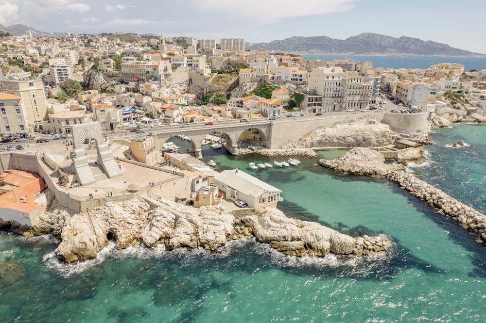 an aerial view of a city next to the ocean