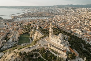 A scenic view of a historic city with a football pitch nestled among old buildings