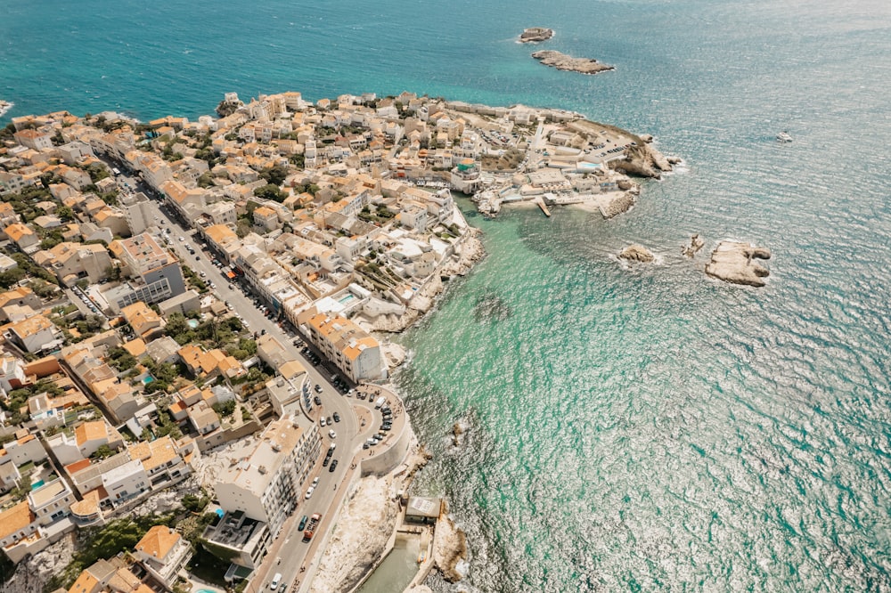 a bird's eye view of a small town next to the ocean