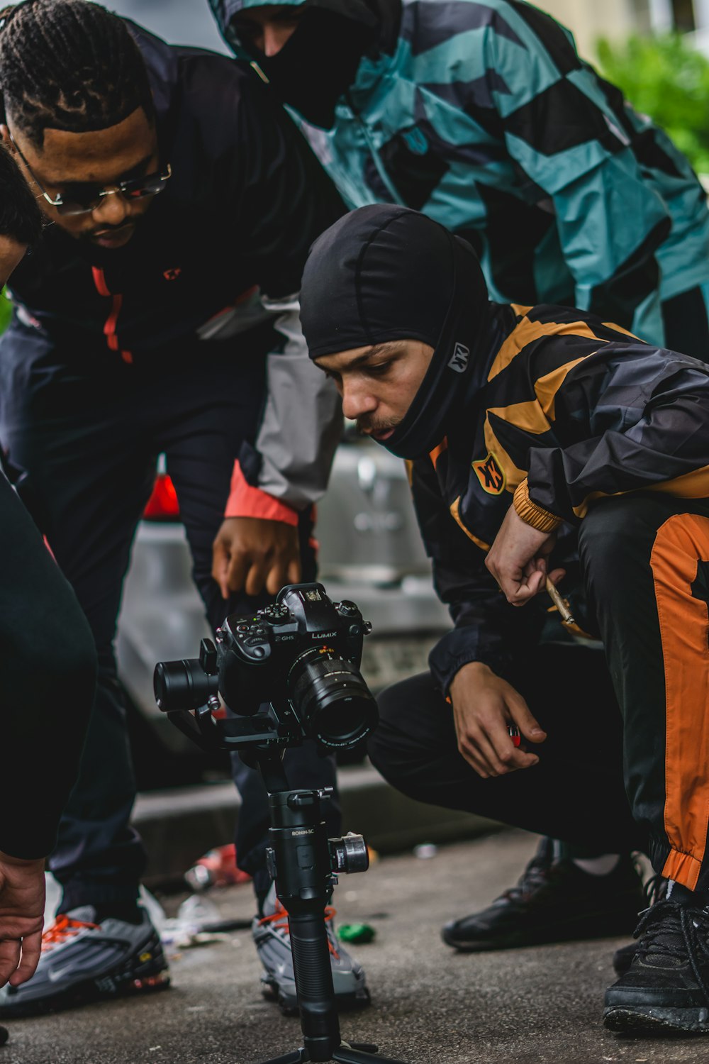 a group of people standing around a camera