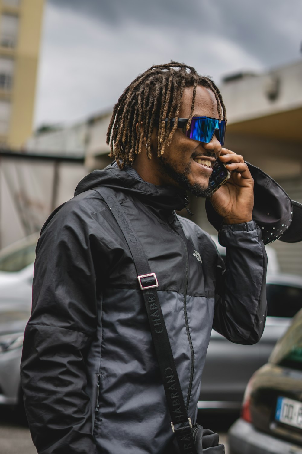 a man with dreadlocks talking on a cell phone