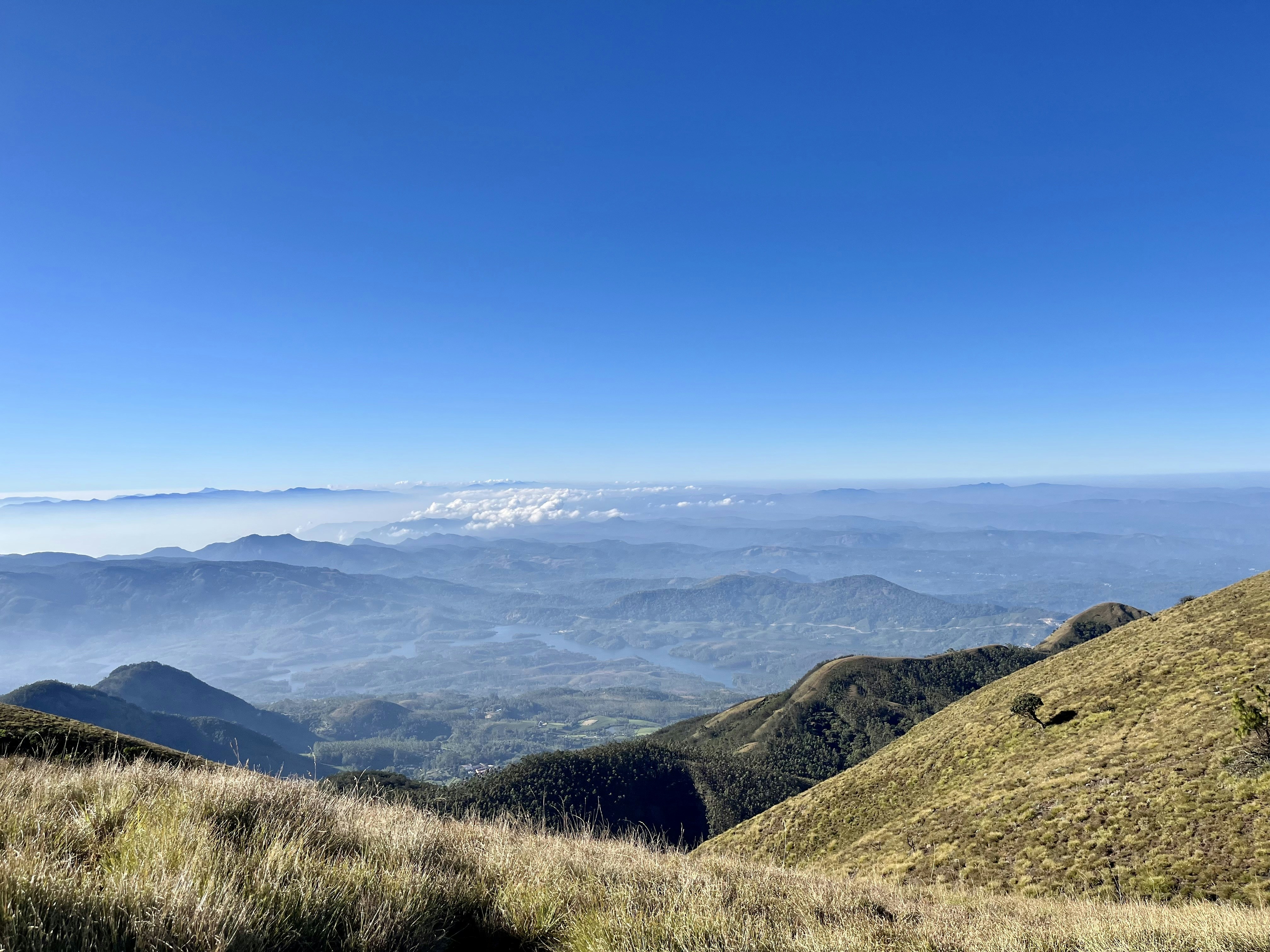 a view of a mountain range with a blue sky in the background