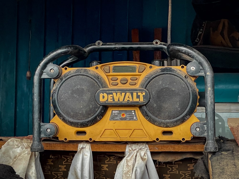 a yellow and black radio sitting on top of a table