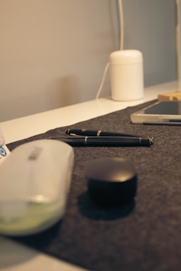 A modern office desk with electronic devices like smartphones and tablets neatly arranged.