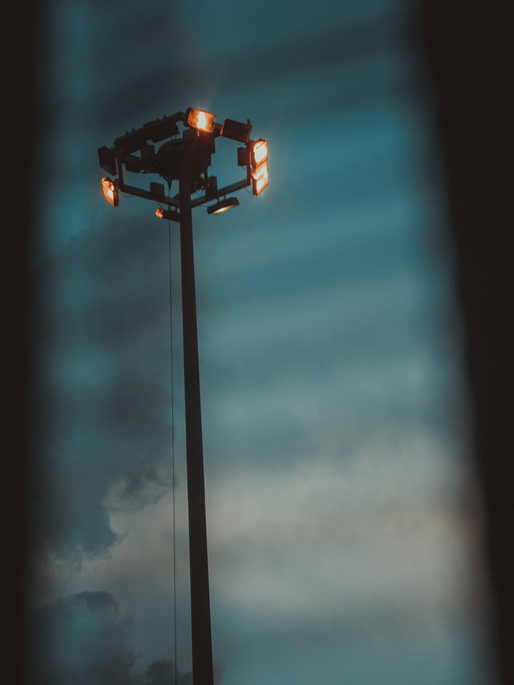 a street light with a cloudy sky in the background