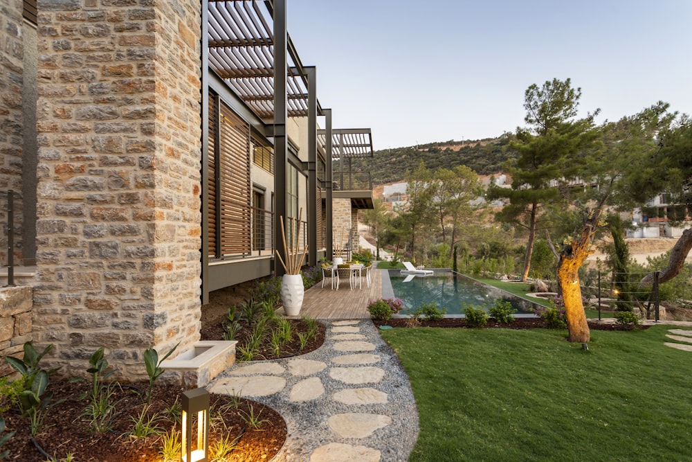 a house with a stone walkway leading to a pool