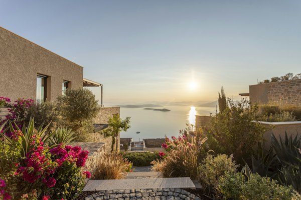 The sun is setting over the water from a house — Bodrum, Turkey