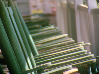 a row of green chairs sitting next to each other