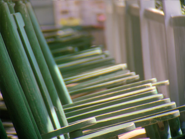 a row of green chairs sitting next to each other
