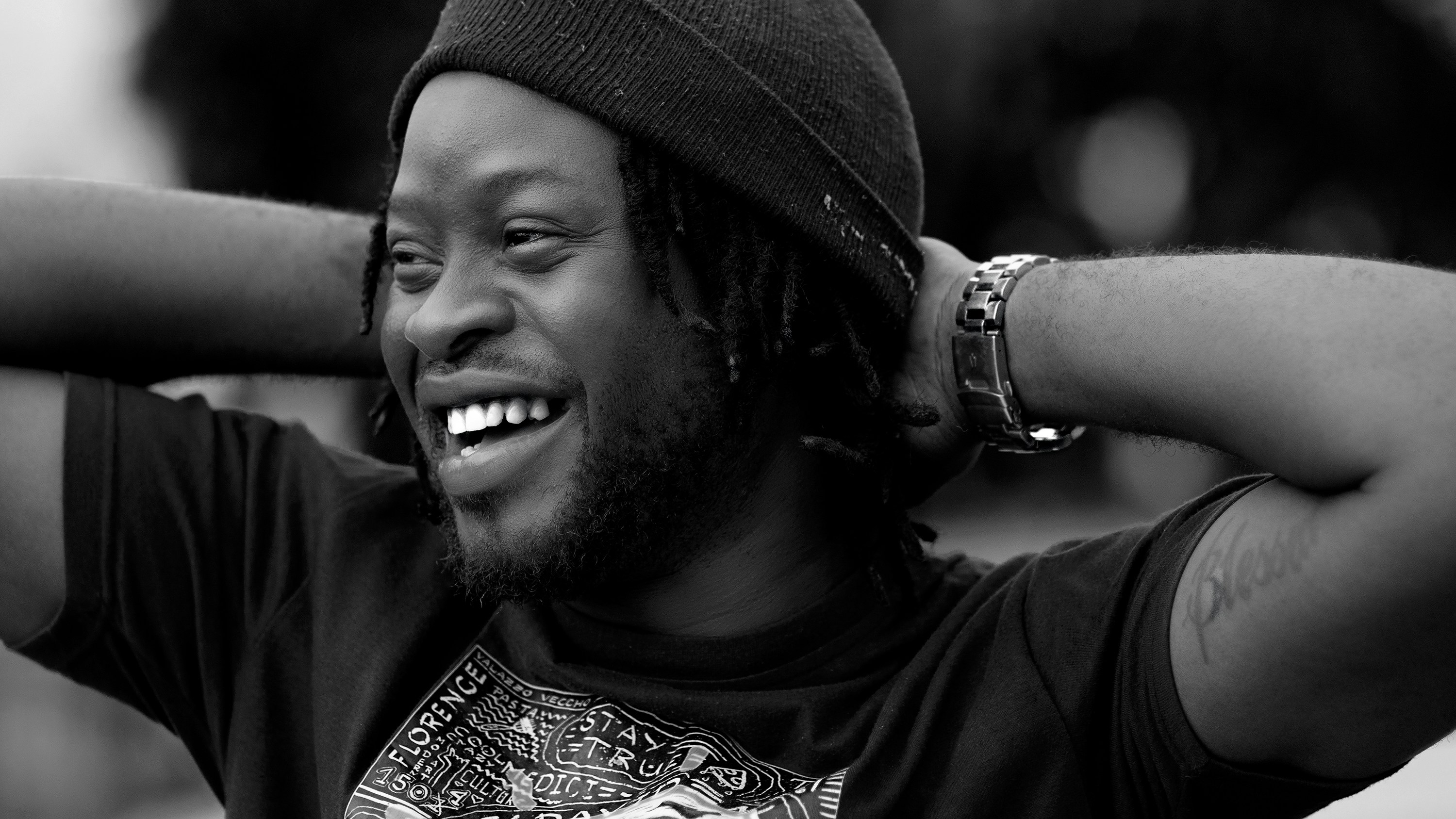a man with dreadlocks and a beanie smiling, Fabrice Agossou en enfant de Vodoun
