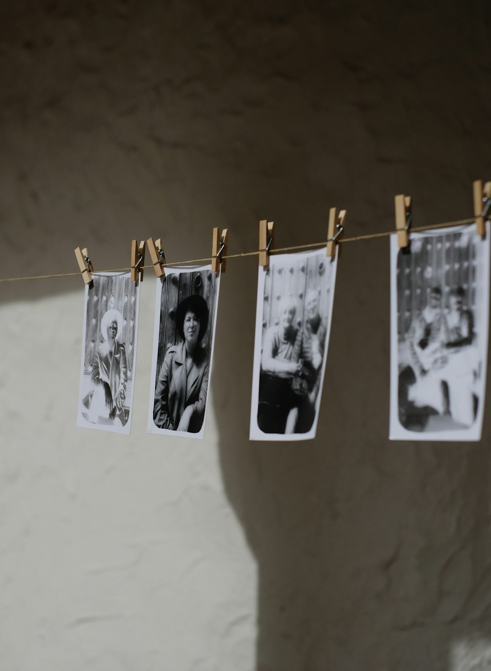 a couple of pictures hanging on a clothes line