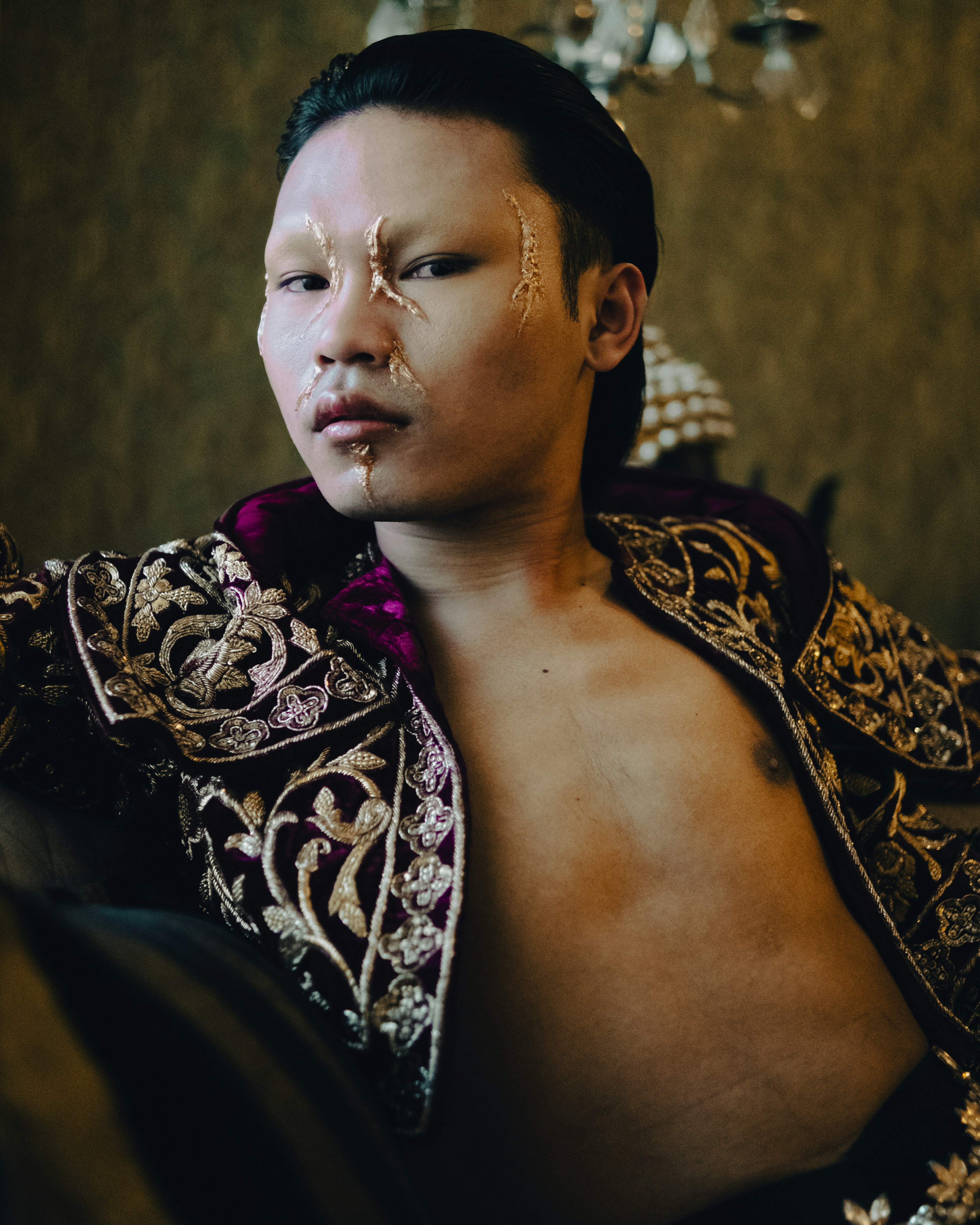 a man with a gold face paint on his face