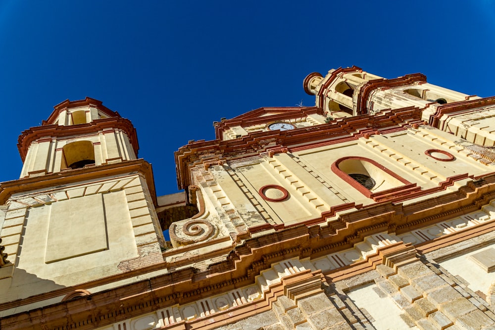 a very tall building with two clocks on each of it's sides