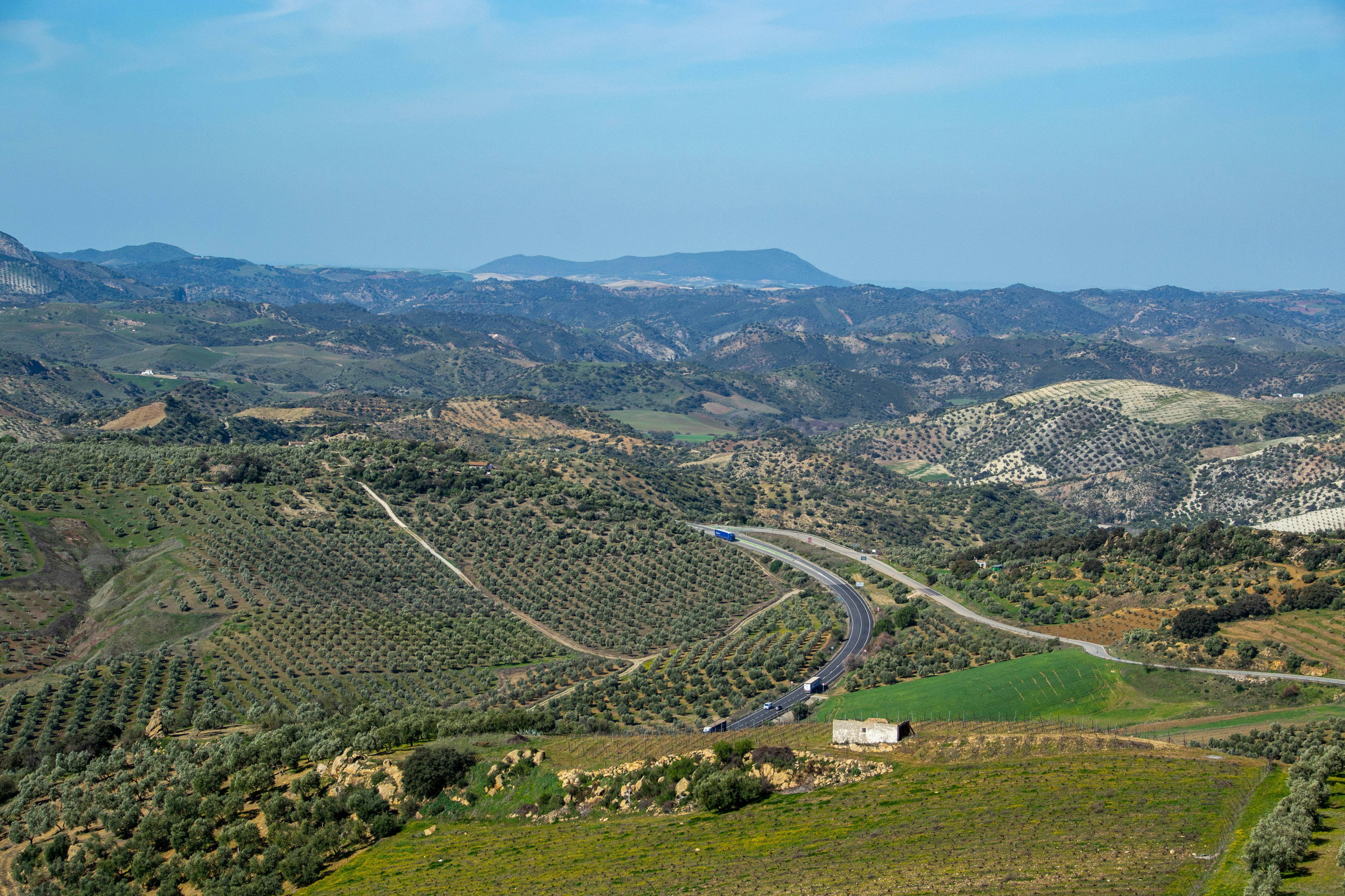 an aerial view of a winding road in the mountains