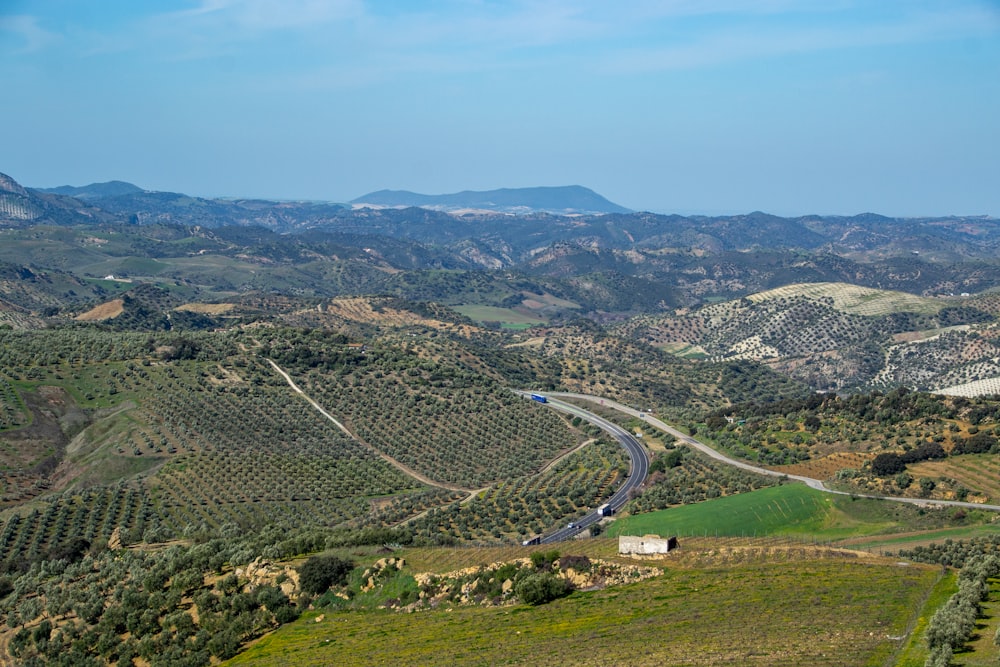 an aerial view of a winding road in the mountains