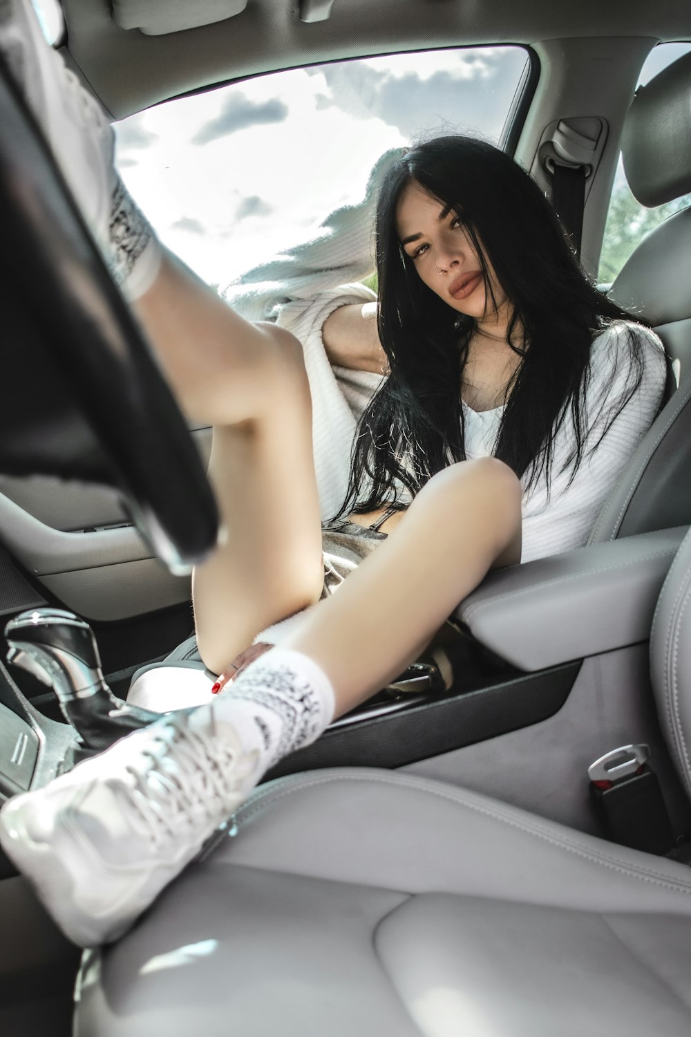 a woman sitting in the back seat of a car